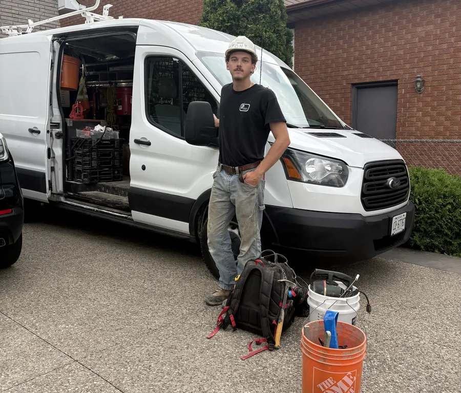 Anthony Panacci, owner of Panacci Plumbing, standing beside his work van with his tools
