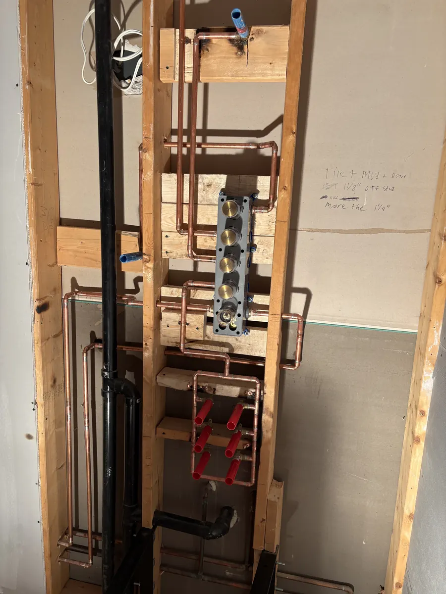 Copper shower valve and supply lines roughed in between wall studs