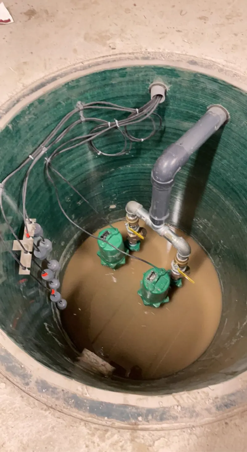 Pump pit with two new pumps, float switches and discharge piping installed by Panacci Plumbing